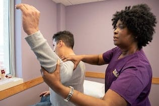 Man having shoulder pain after a car accident getting treatment by nurse