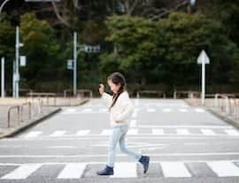 girl crossing the street about to get in accident and need an accident doctor