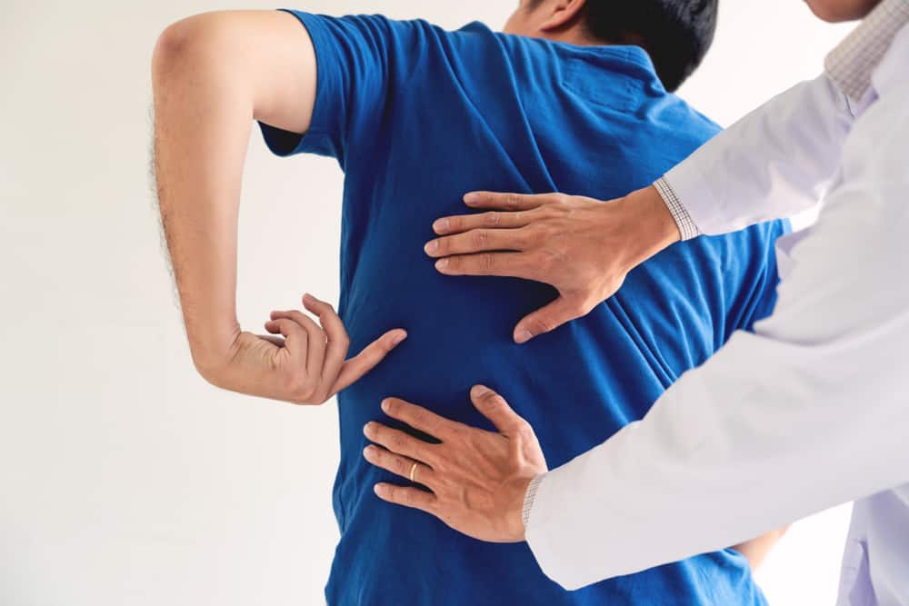 Stomach and Back Pain at the Same Time - AICA Orthopedics