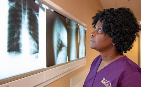 Stockbridge AICA nurse looking at XRAY and scan of ribcage 